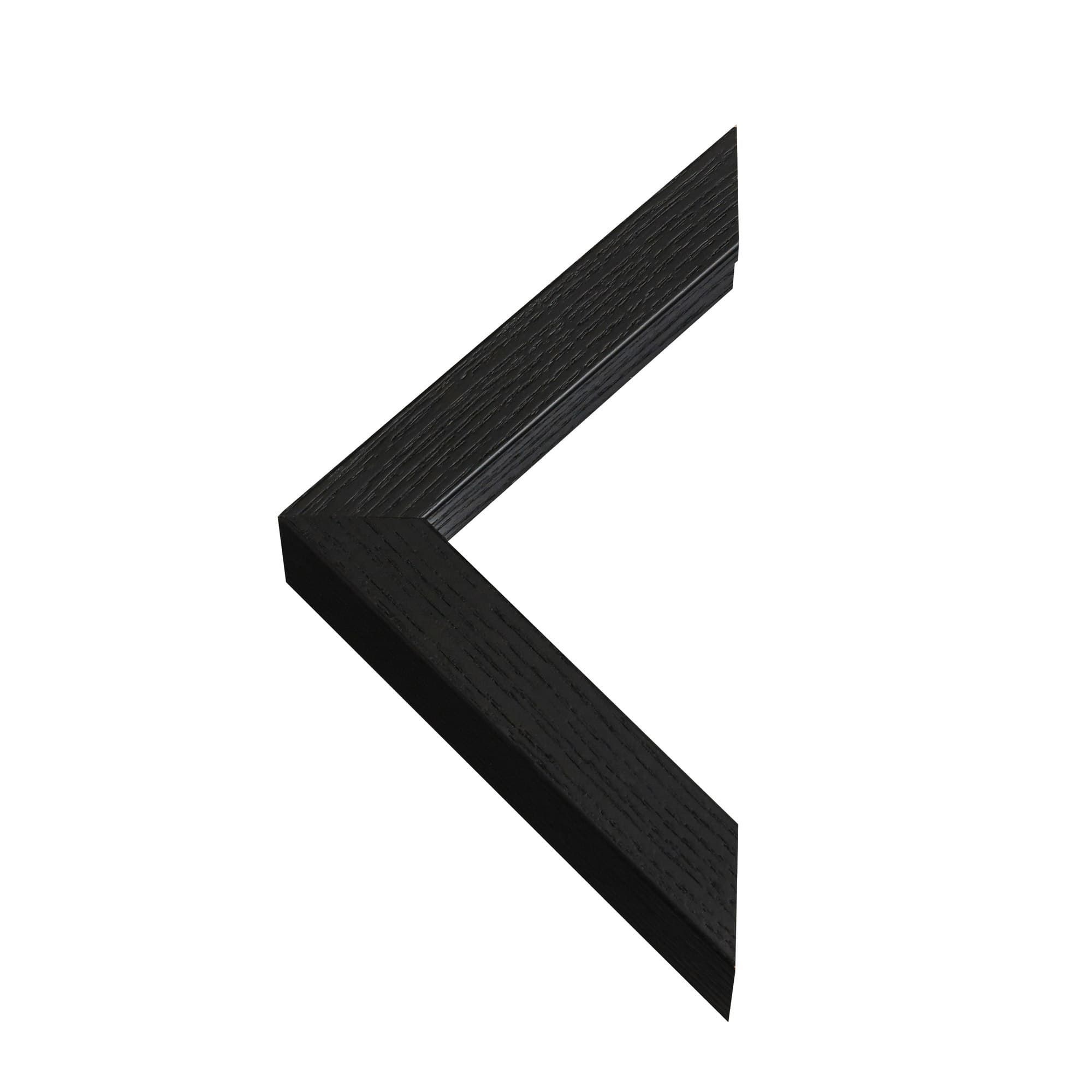 Closeup of a black box frame corner — matte edge, glass surface, and mitred wood join visible.
