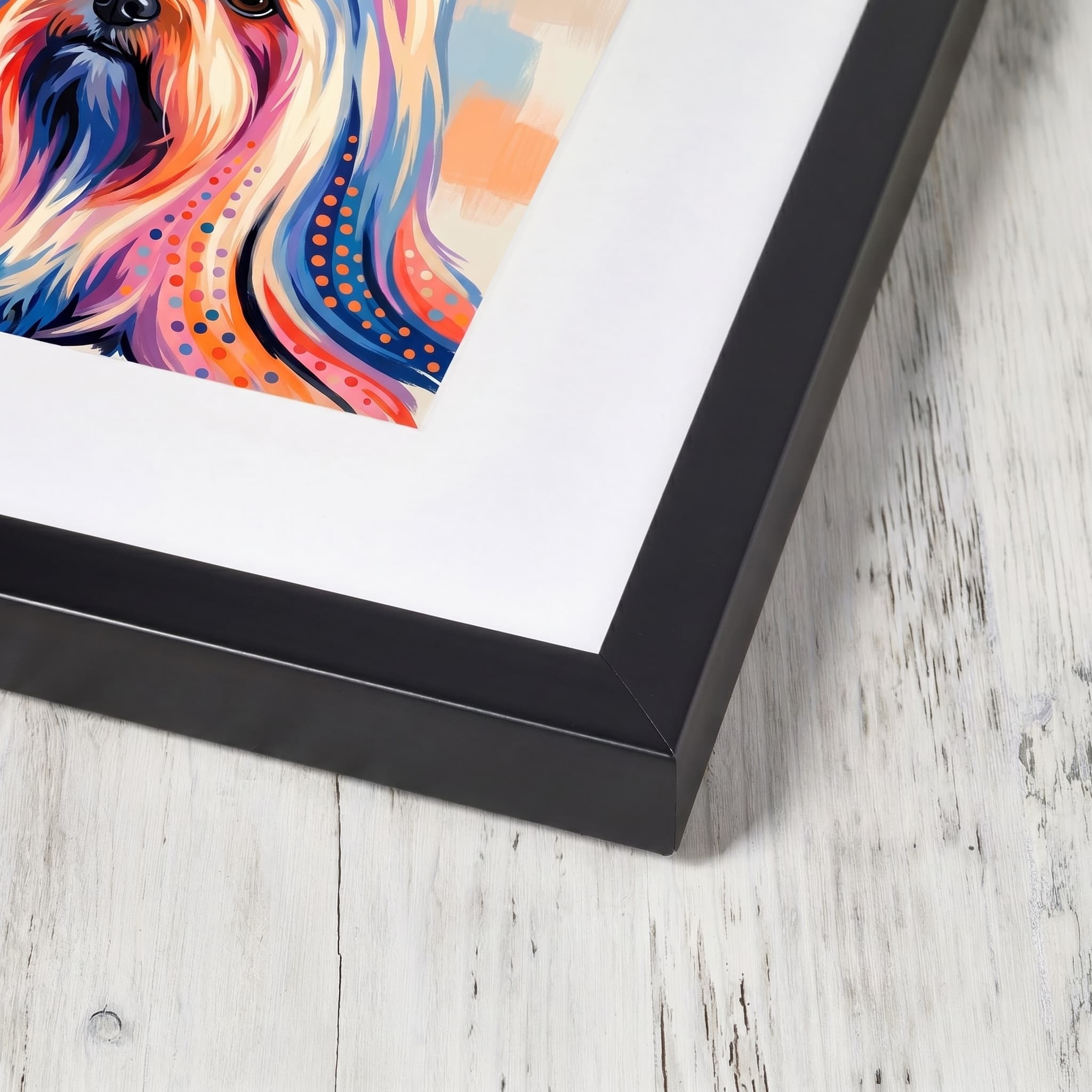 A pet portrait in a slim black classic wood frame with a wide snow-white mount, near-corner view.